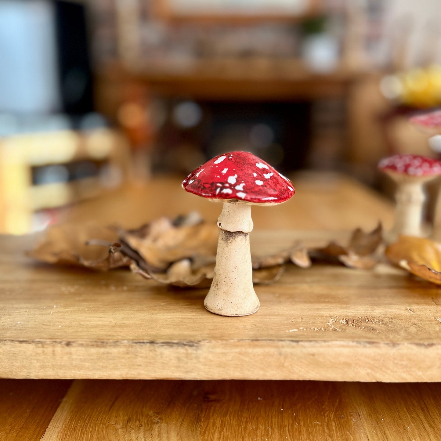 Small decorative mushroom on a wooden surface with a blurred background