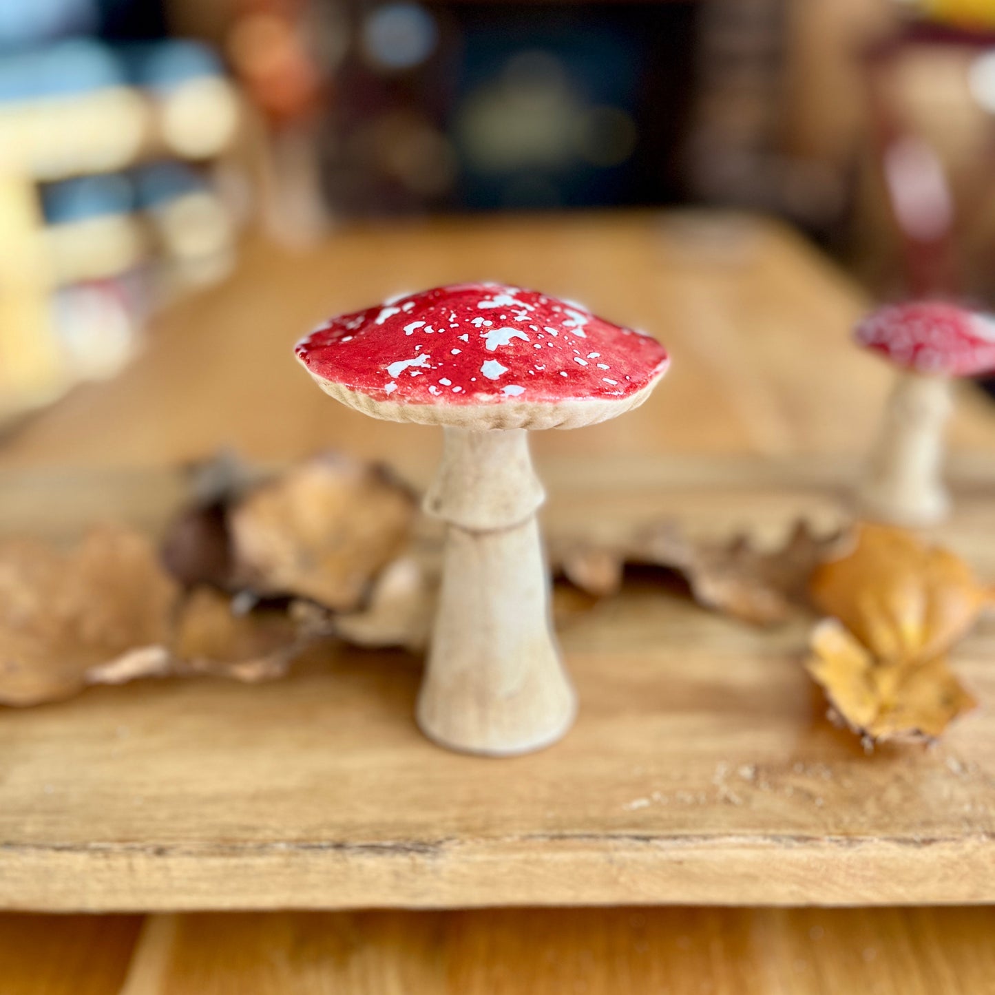 Decorative mushroom with red cap on a wooden surface