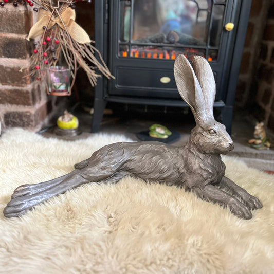 Large hare ornament on a sheepskin rug in front of an electric fire