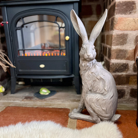 Decorative hare statue in front of a fireplace