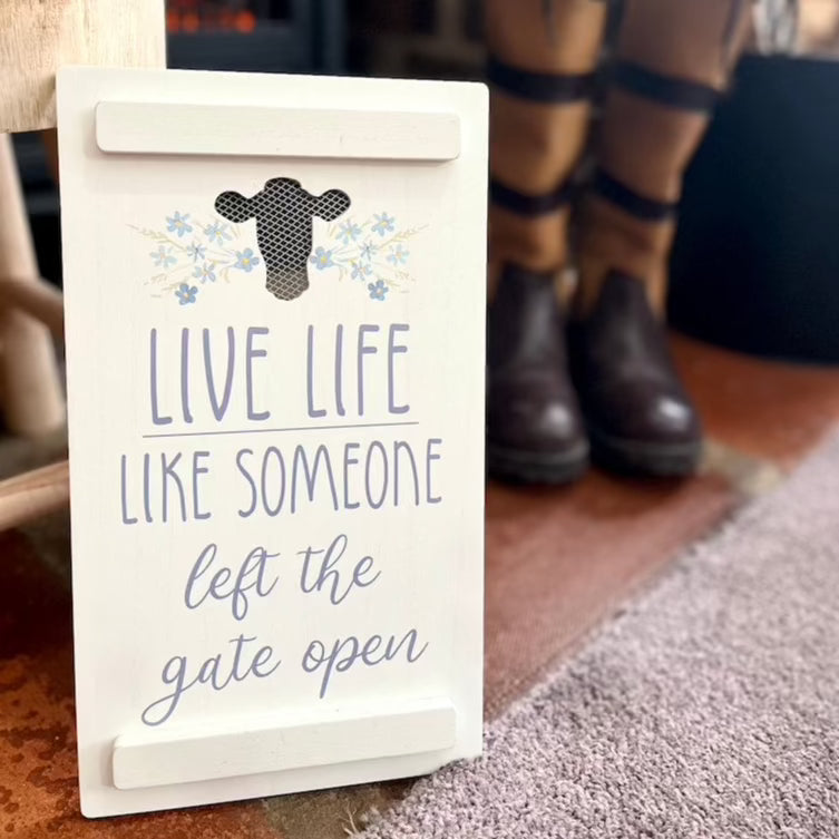 Wooden Cow Quote Sign Displayed with Country Boots & Fireplace
