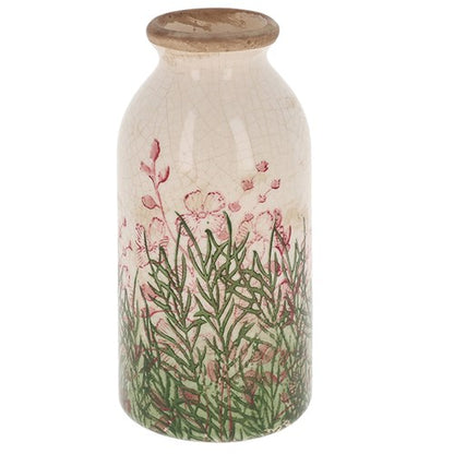 Decorative bottle vase with floral design and wooden cap on a white background