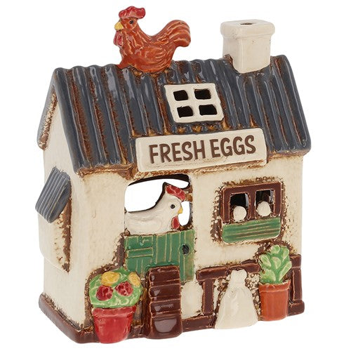 Decorative ceramic chicken coop with a rooster on top, featuring 'Fresh Eggs' text.