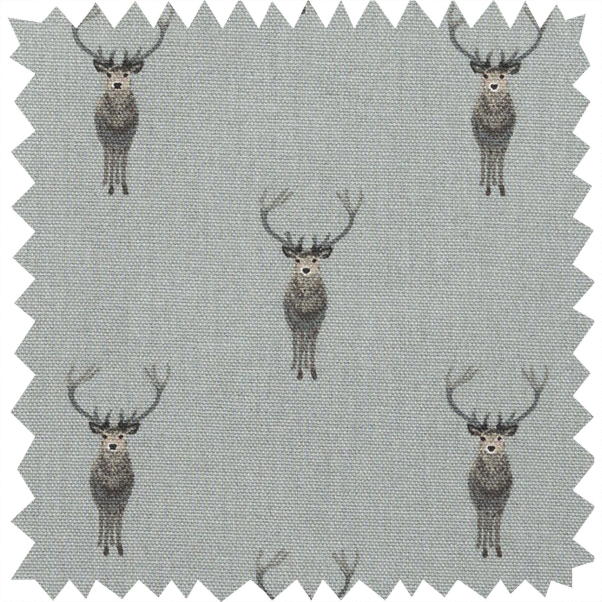 A square fabric swatch with zigzag-cut edges, featuring a repeating pattern of grey and brown deer on a light grey background.