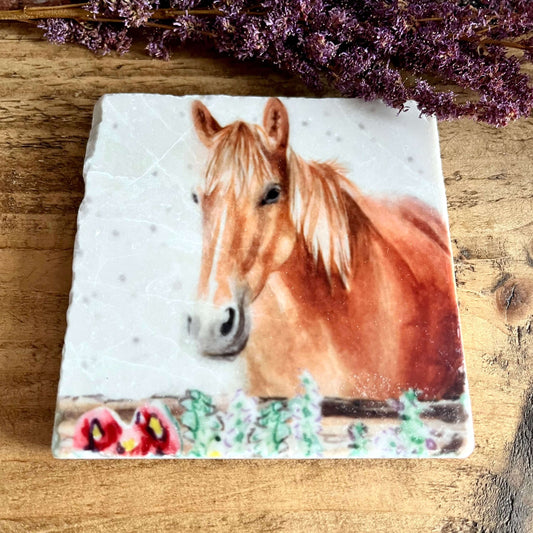 A square natural marble coaster with a watercolour painted horse head, displayed on a shelf with purple dried flowers as decoration.