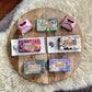 Assorted soaps on a wooden tray with a white fur background