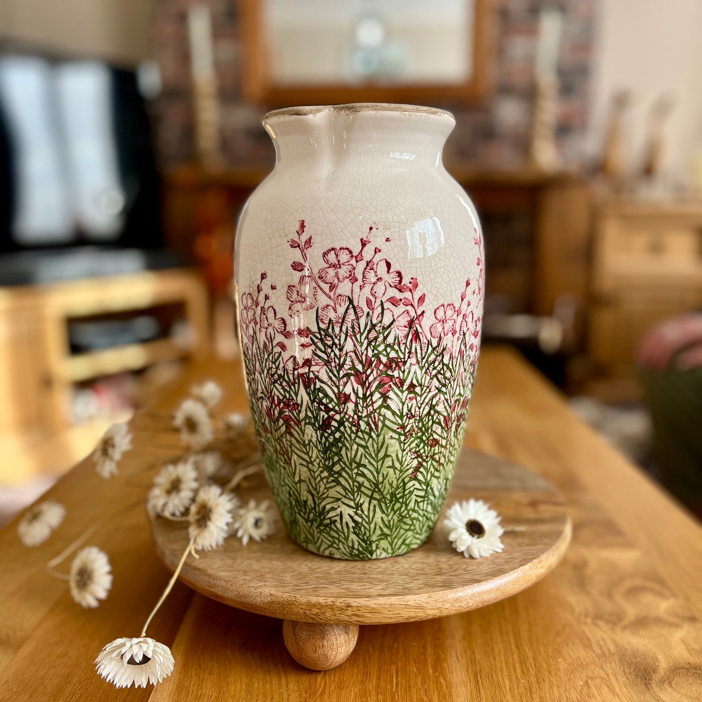 Decorative vase with floral design on a wooden table