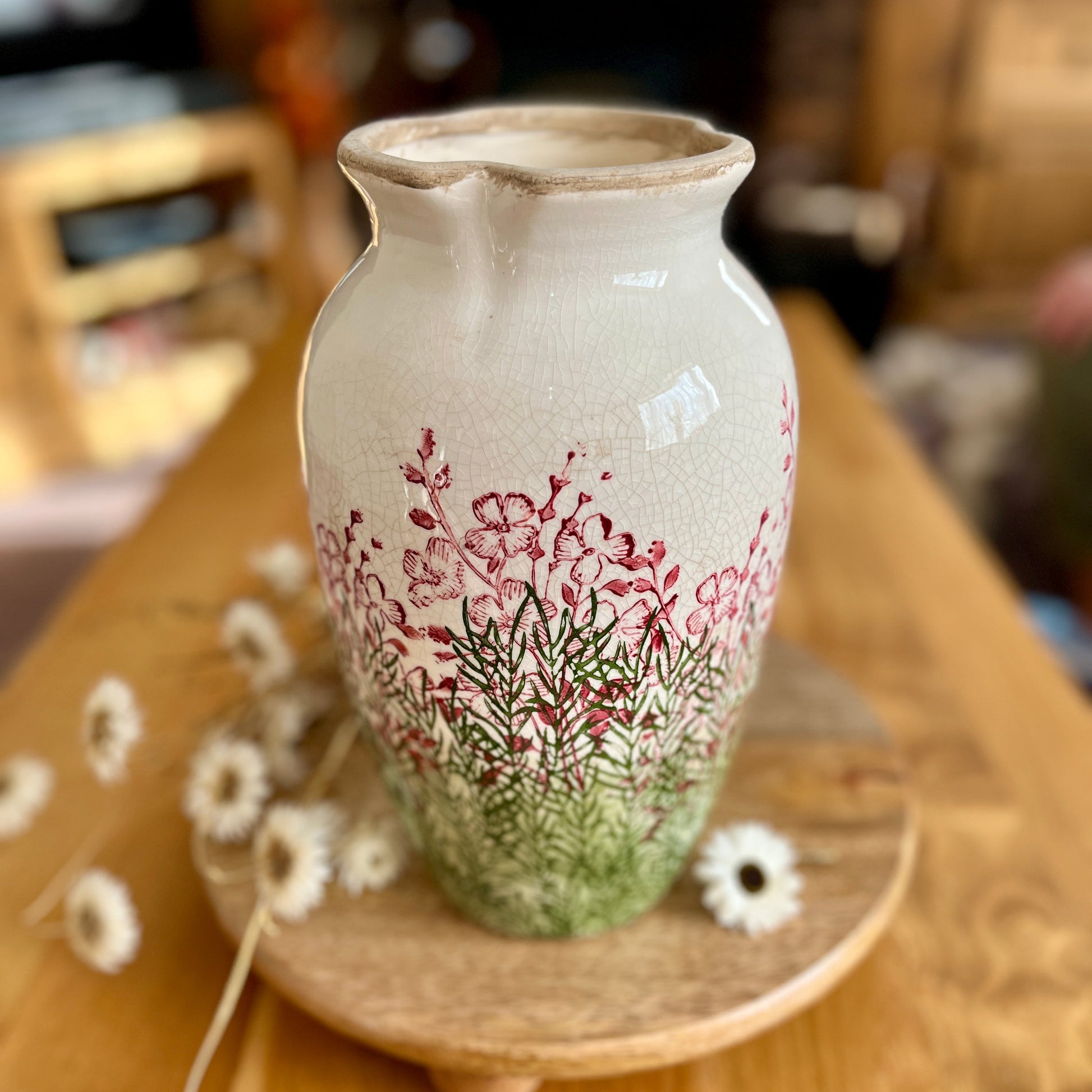 Decorative vase with floral design on a wooden surface