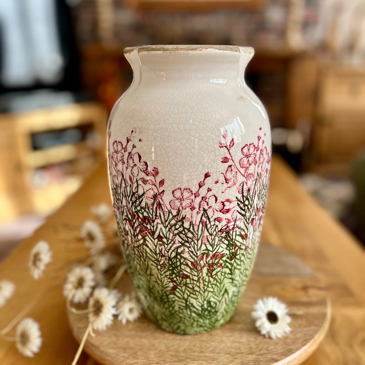Decorative vase with floral patterns on a wooden surface