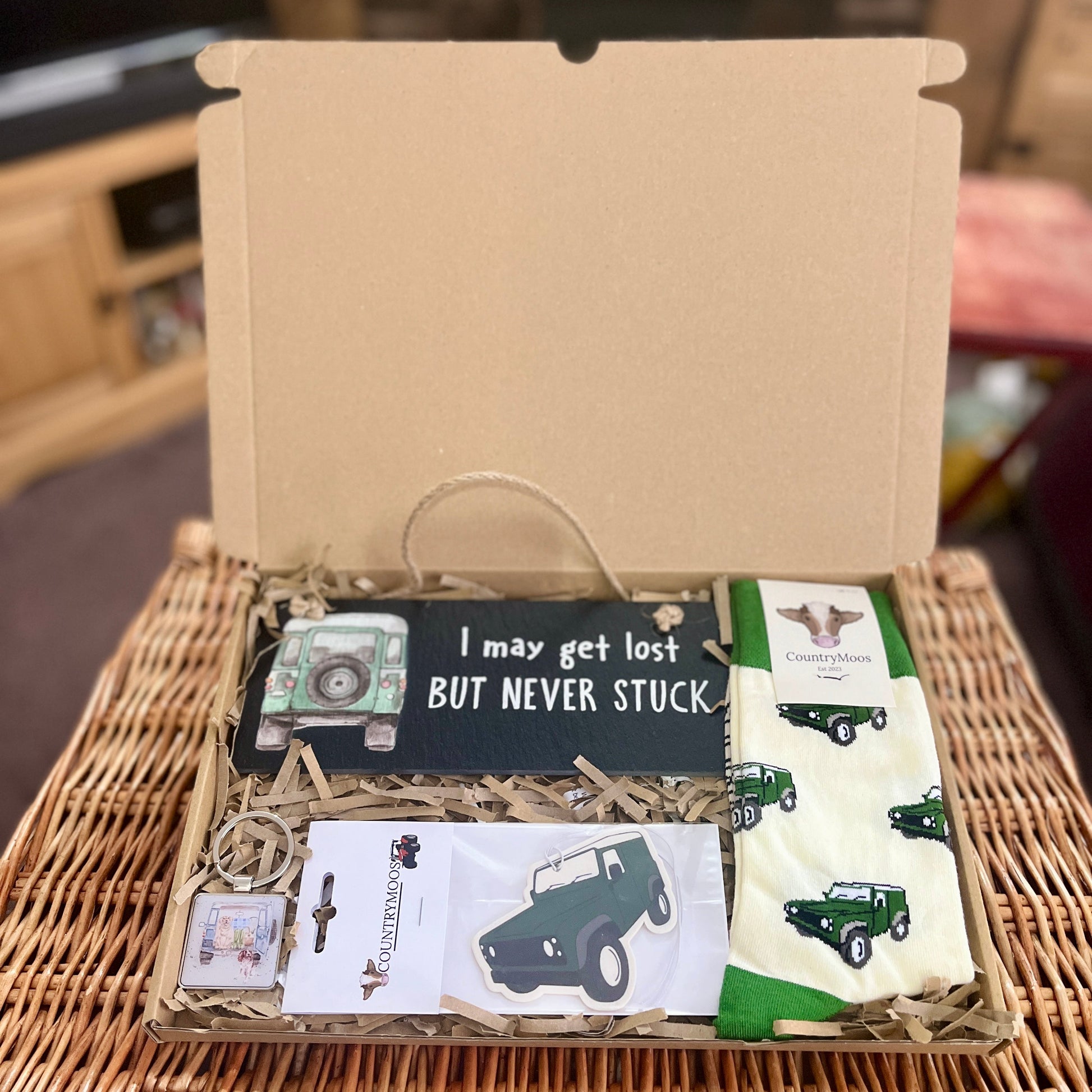 Box with Land Rover items on a woven surface