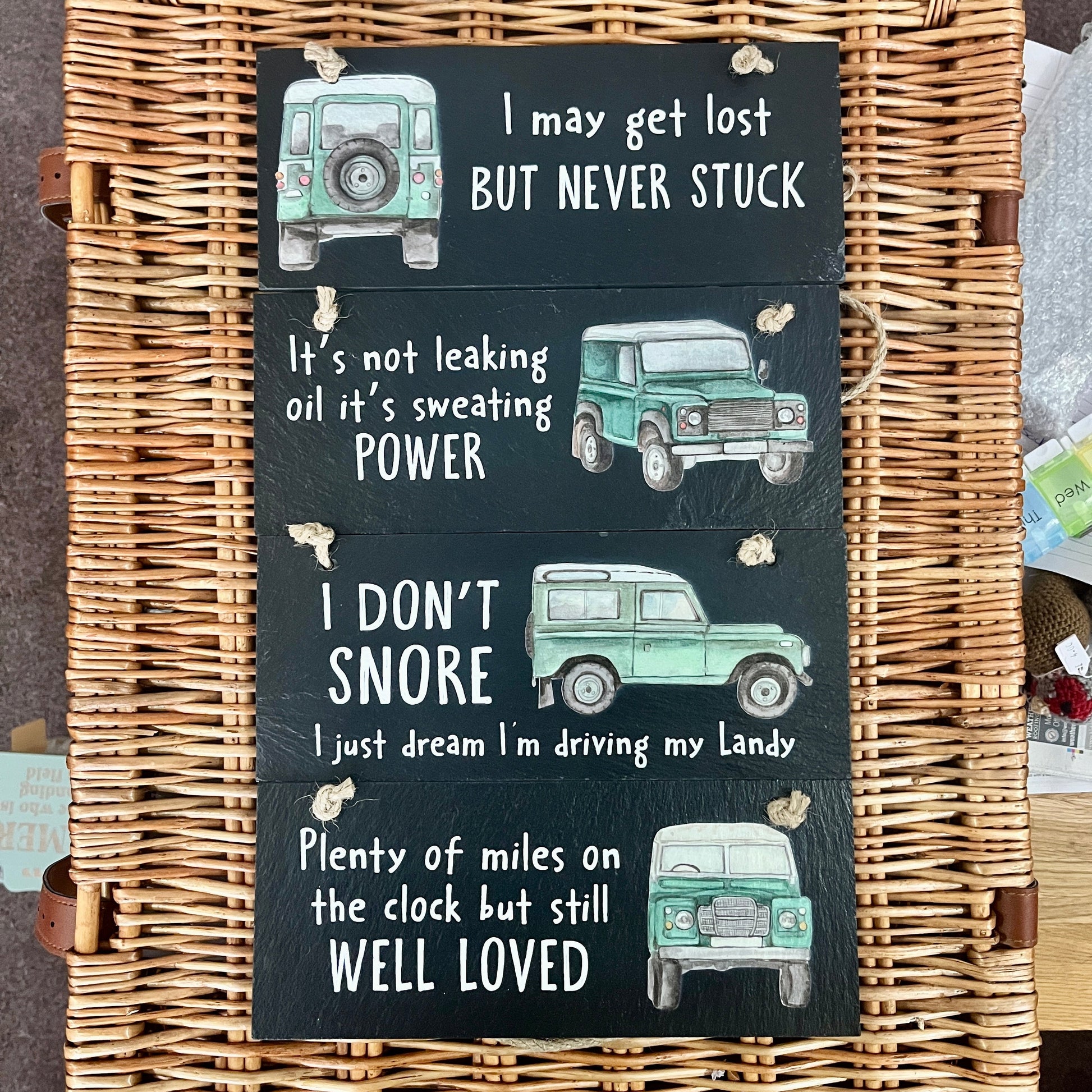 Wicker basket with 4 slate plaques featuring Land Rover illustrations and text.