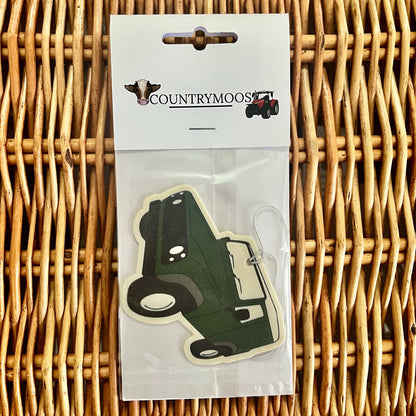 Green Land Rover shaped air freshener in clear packaging on a wicker surface with 'Countrymoos' branding.