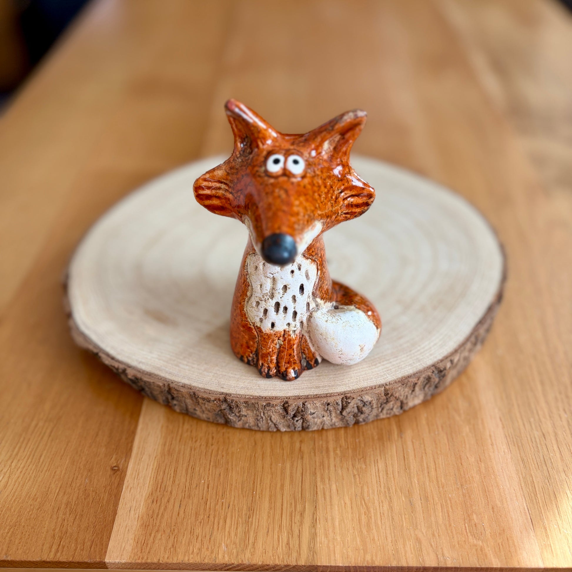 Fox figurine on a wooden base on a table