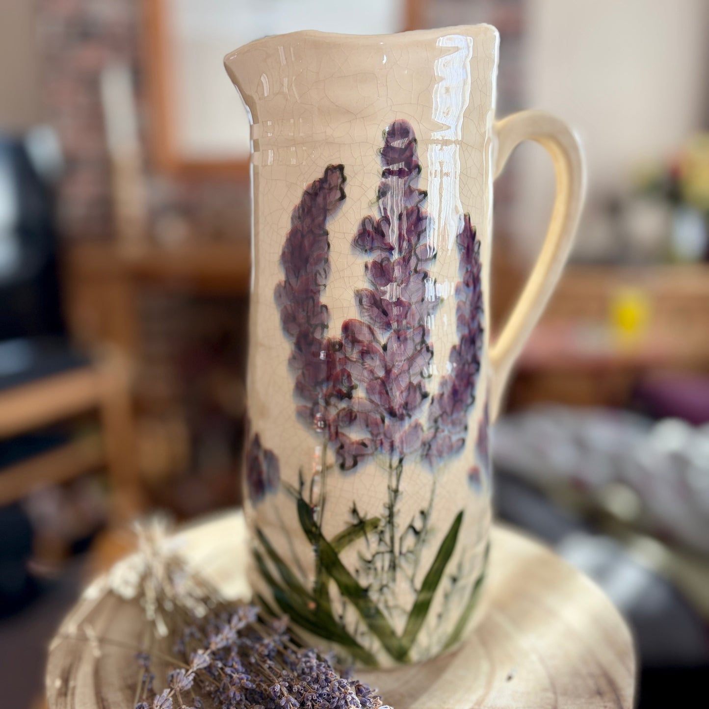 Ceramic jug with lavender design on a wooden block