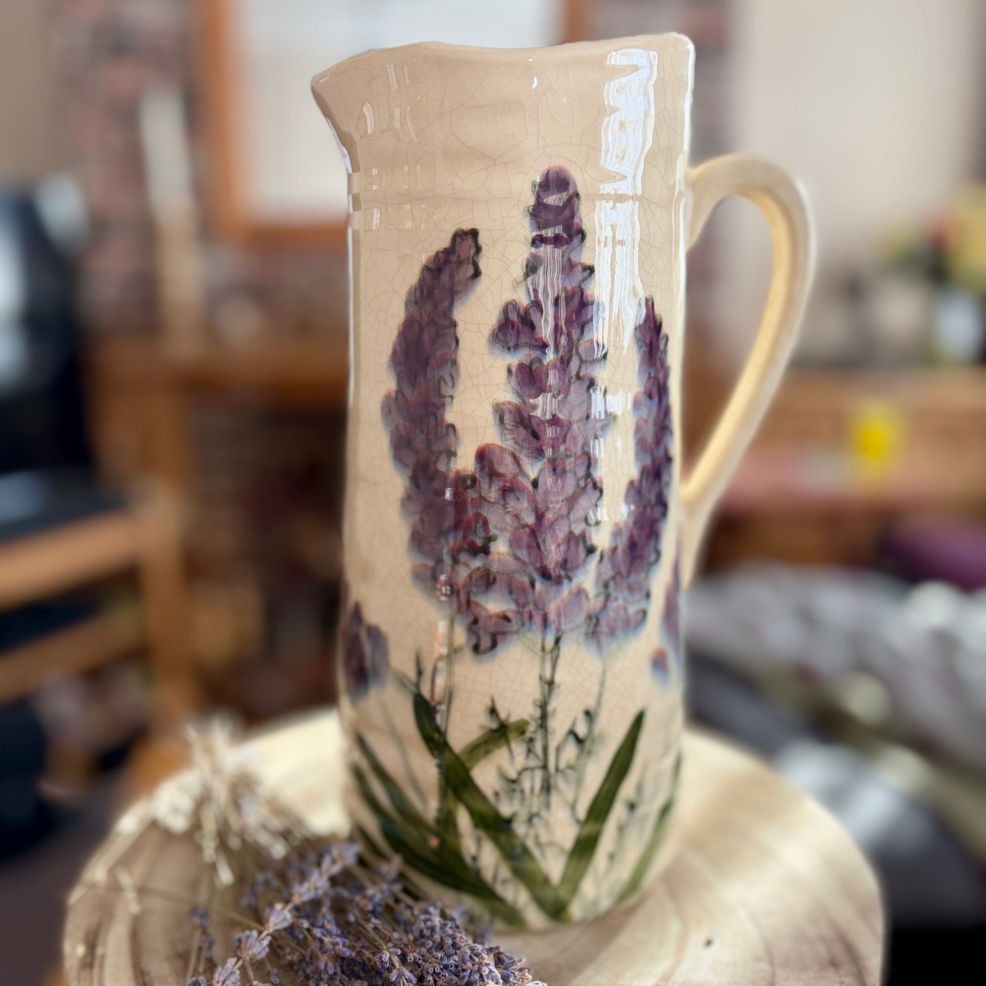 Ceramic jug with lavender design on a wooden block
