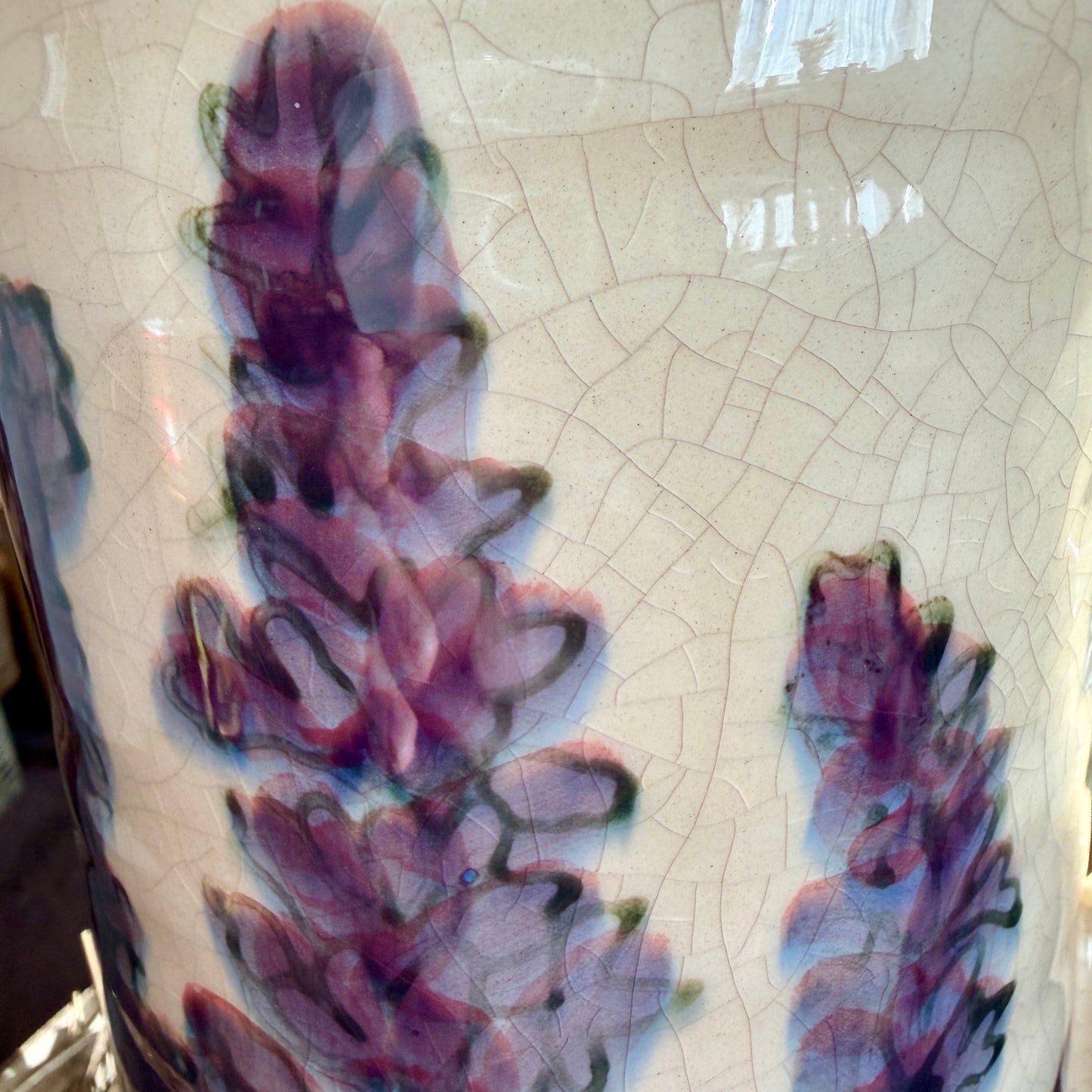 Ceramic vase with floral design on a textured surface