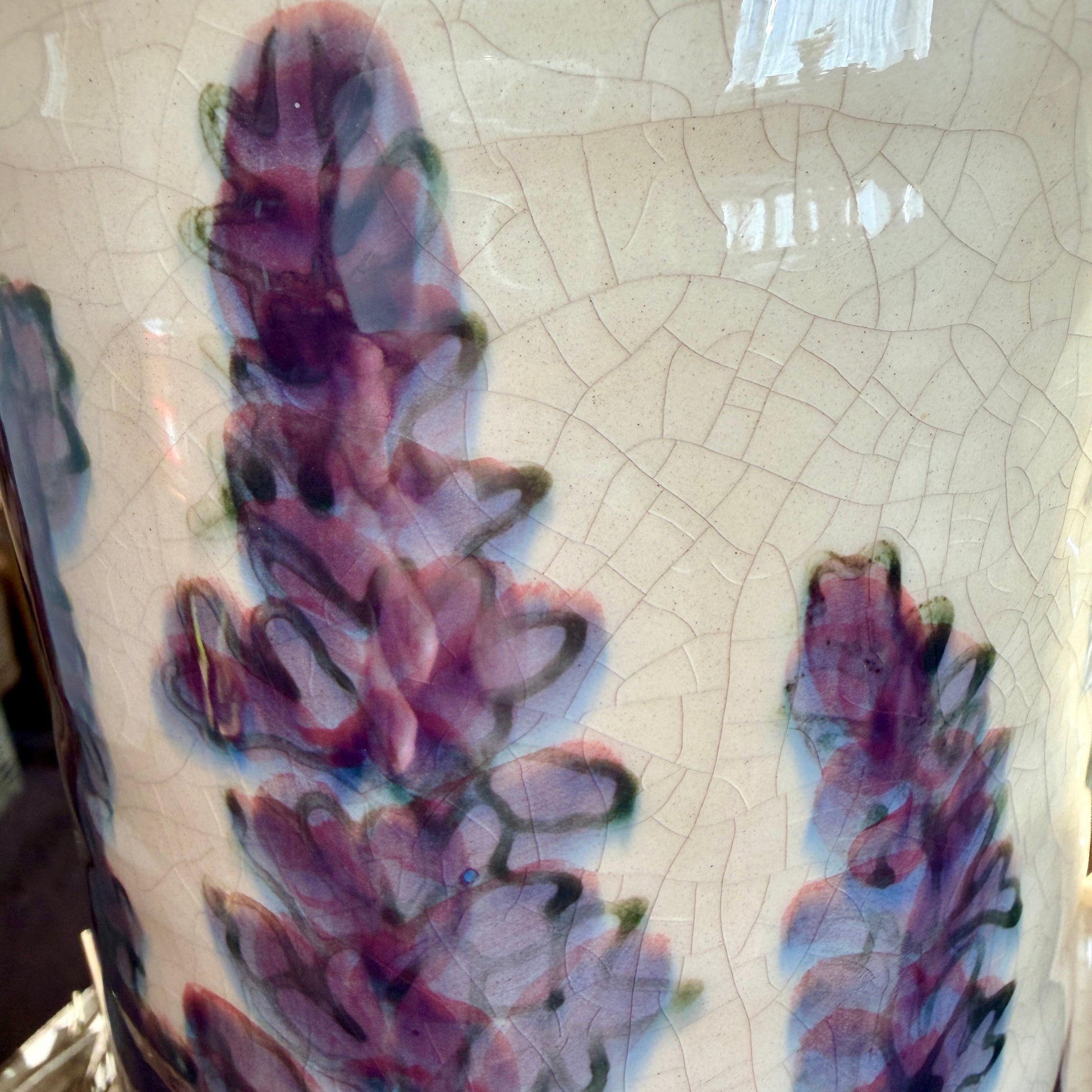 Ceramic vase with floral design on a textured surface