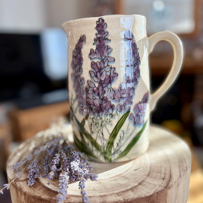 Ceramic jug with lavender design on a wooden stand