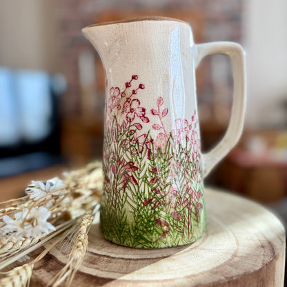 Ceramic jug with floral design on a wooden surface in home setting