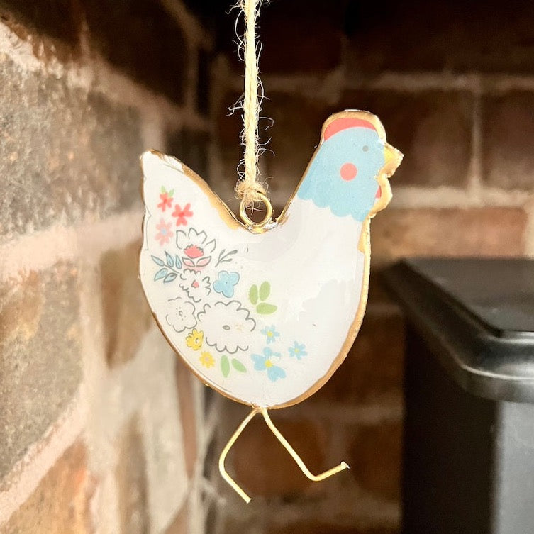 Blue Face Chicken Hanger Displayed by Fireplace