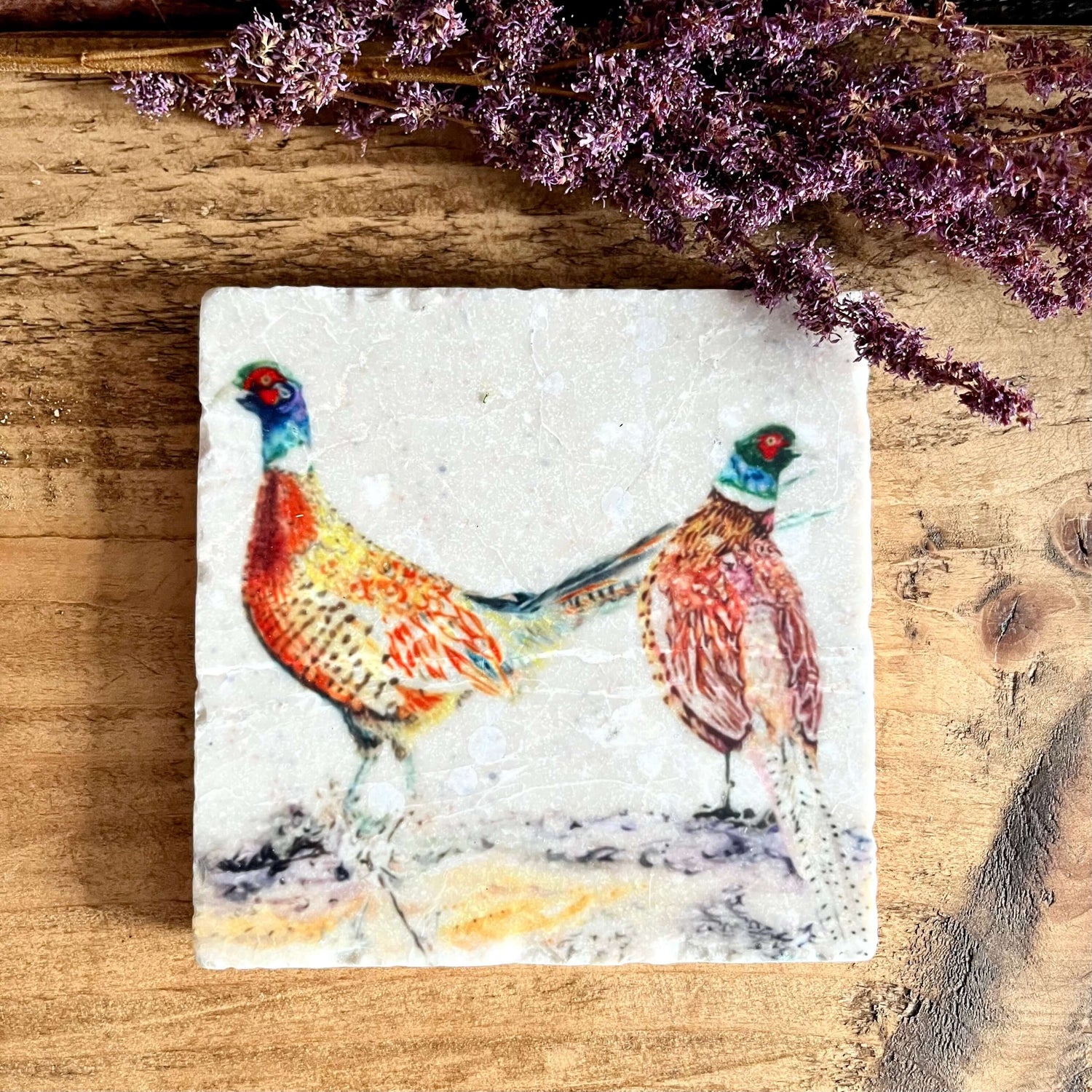 Image of a square marble coaster with watercolour painted bold male pheasants.