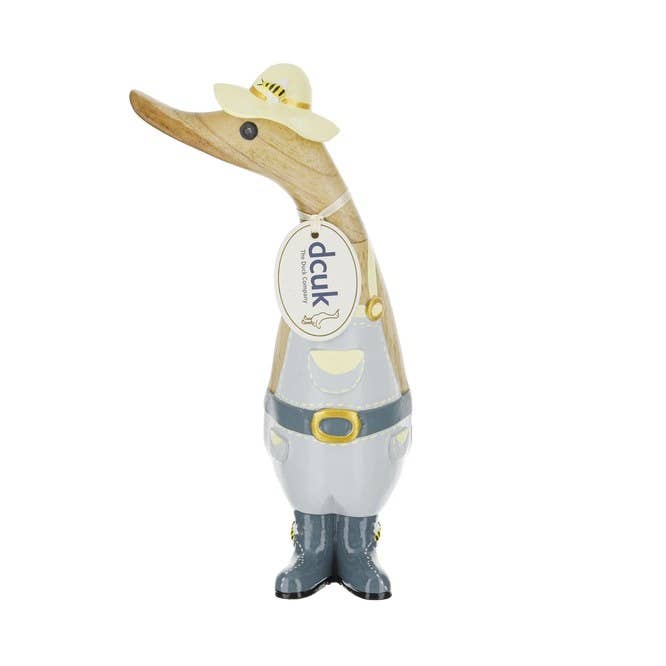 Decorative duck figurine wearing a hat and tie on a white background